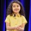 Eliana Fernandez in a yellow shirt with flowers speaking