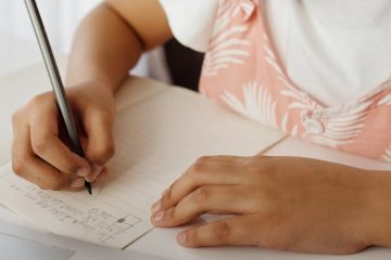 Little Girl writing in notebook