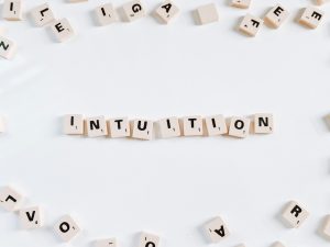 brown scrabble game tiles spelling Intuition